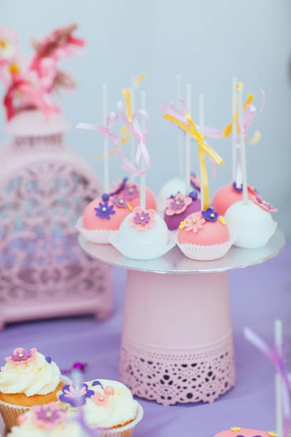 Beautiful composition of children's sweets-cakes decorated with bows and flowers