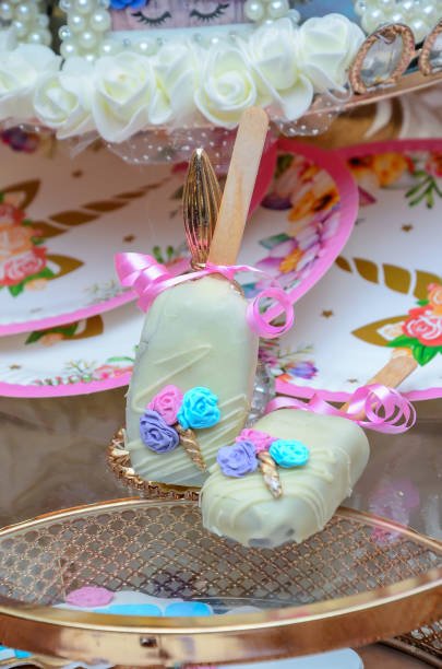 Cake lollipop with white glaze and sprinkles.theme unicorn